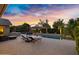 Resort-style pool area with comfortable lounge chairs, outdoor kitchen, and lush landscaping at 2094 E Aris Dr, Gilbert, AZ 85298