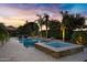 Inviting pool and spa with fire features, set against a beautiful sunset backdrop at 2094 E Aris Dr, Gilbert, AZ 85298