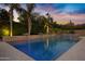Refreshing pool with cascading water features surrounded by palm trees and lush landscaping at 2094 E Aris Dr, Gilbert, AZ 85298