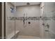 Modern shower with custom tile work, multiple shower heads, and a built-in bench, creating a spa-like retreat at 2094 E Aris Dr, Gilbert, AZ 85298