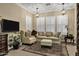 Cozy sitting room with comfortable seating, natural light from shuttered windows, and classic design elements at 2094 E Aris Dr, Gilbert, AZ 85298