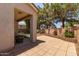 Covered back patio featuring a tile surface, and backyard with mature trees at 2150 E Sunland Ave, Phoenix, AZ 85040