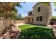 Spacious backyard featuring artificial turf, garden, brick wall, and covered patio at 2150 E Sunland Ave, Phoenix, AZ 85040