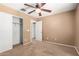 Bedroom with carpet flooring, closet, and ceiling fan at 2150 E Sunland Ave, Phoenix, AZ 85040