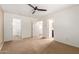 Spacious bedroom with plush carpet and multiple doorways, including one to the bathroom and one to the closet at 2150 E Sunland Ave, Phoenix, AZ 85040
