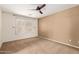 Bright bedroom with neutral tones, a large window, and plush carpet for a comfortable living space at 2150 E Sunland Ave, Phoenix, AZ 85040