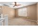 Bedroom with neutral carpet, ceiling fan, and view from the landing at 2150 E Sunland Ave, Phoenix, AZ 85040