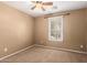 Neutral-toned bedroom with a ceiling fan and a large window for natural light at 2150 E Sunland Ave, Phoenix, AZ 85040