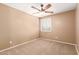 Neutral-toned bedroom featuring a ceiling fan, a window, and carpet flooring, creating a cozy atmosphere at 2150 E Sunland Ave, Phoenix, AZ 85040
