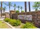 Stone sign for the Copper Leaf South Mountain Village community, surrounded by palm trees and landscaping at 2150 E Sunland Ave, Phoenix, AZ 85040