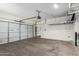 Spacious garage with bright lighting, door, and garage door opener at 2150 E Sunland Ave, Phoenix, AZ 85040