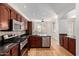 Spacious kitchen featuring granite countertops, stainless steel appliances, and modern fixtures at 2150 E Sunland Ave, Phoenix, AZ 85040