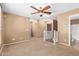Neutral toned living room featuring a ceiling fan and staircase, providing open and airy appeal at 2150 E Sunland Ave, Phoenix, AZ 85040