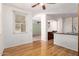Living room with hardwood floors, neutral paint, and views into an eat-in kitchen at 2150 E Sunland Ave, Phoenix, AZ 85040