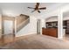 Bright living room with hardwood floors, ceiling fan, and staircase at 2150 E Sunland Ave, Phoenix, AZ 85040
