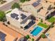 Aerial view of private backyard oasis featuring a sparkling pool, patio seating, and lush green lawn at 2185 E Gillcrest Rd, Gilbert, AZ 85298