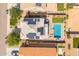 Aerial view of a home with solar panels, backyard swimming pool, patio seating, and green lawn at 2185 E Gillcrest Rd, Gilbert, AZ 85298