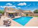 Stunning backyard pool with patio seating and beautiful landscaping on a sunny day at 2185 E Gillcrest Rd, Gilbert, AZ 85298