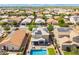 Aerial view of a home with solar panels and a backyard featuring pool, spa, patio, and green lawn at 2185 E Gillcrest Rd, Gilbert, AZ 85298