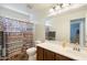 Well-lit bathroom with single sink vanity and shower at 2185 E Gillcrest Rd, Gilbert, AZ 85298