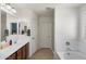 Bright bathroom with a large vanity, soaking tub, and separate glass-enclosed shower at 2185 E Gillcrest Rd, Gilbert, AZ 85298