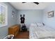 Bright bedroom with a ceiling fan, hard flooring, and modern window shutters at 2185 E Gillcrest Rd, Gilbert, AZ 85298