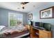 Bedroom featuring natural light, window shutters, a desk and a ceiling fan at 2185 E Gillcrest Rd, Gilbert, AZ 85298