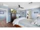 Primary bedroom with a mounted television, ceiling fan, and ensuite bathroom at 2185 E Gillcrest Rd, Gilbert, AZ 85298