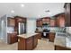 Modern kitchen featuring stainless steel appliances, granite countertops, and a central island at 2185 E Gillcrest Rd, Gilbert, AZ 85298
