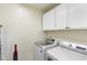 Functional laundry room with washer, dryer, and cabinet storage at 2185 E Gillcrest Rd, Gilbert, AZ 85298