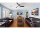 Comfortable living room featuring hardwood floors, ceiling fan, and ample seating at 2185 E Gillcrest Rd, Gilbert, AZ 85298