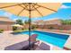 Backyard oasis featuring a sparkling pool, lush greenery, lounge chairs, and patio furniture, ideal for relaxation at 2185 E Gillcrest Rd, Gilbert, AZ 85298
