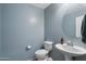 Stylish powder room with a pedestal sink and light blue walls at 2185 E Gillcrest Rd, Gilbert, AZ 85298
