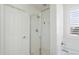 Close-up of a modern bathroom shower with glass door and sleek fixtures; bathtub visible on right side at 2185 E Gillcrest Rd, Gilbert, AZ 85298