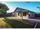 Spacious backyard featuring a covered patio, green lawn, and mature landscaping for outdoor enjoyment at 2281 E Saratoga St, Gilbert, AZ 85296