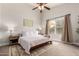 Bright primary bedroom with neutral walls, a ceiling fan, a queen-size bed and hardwood floors at 2281 E Saratoga St, Gilbert, AZ 85296