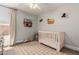 Cozy Bedroom with neutral walls, a modern crib, a ceiling fan and a patterned rug at 2281 E Saratoga St, Gilbert, AZ 85296