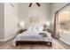 Bright primary bedroom with neutral walls, a ceiling fan, a queen-size bed and hardwood floors at 2281 E Saratoga St, Gilbert, AZ 85296