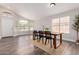 Bright dining room with a dark wood table, black chairs, wood floors and natural light at 2281 E Saratoga St, Gilbert, AZ 85296
