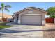Traditional home featuring a beige exterior, two car garage, and a well-maintained front yard at 2281 E Saratoga St, Gilbert, AZ 85296