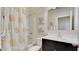 Cozy bathroom with a shower-tub combo, decorative shower curtain, and stylish vanity mirror at 24052 W Pima St, Buckeye, AZ 85326