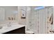 Bright bathroom featuring a shower, modern fixtures, and neutral decor at 24052 W Pima St, Buckeye, AZ 85326