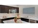 Well-designed kitchen with stainless steel appliances, ample cabinet space, and a modern sink at 24052 W Pima St, Buckeye, AZ 85326