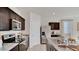 Well-equipped kitchen with sleek countertops, dark wood cabinets, and modern appliances at 24052 W Pima St, Buckeye, AZ 85326