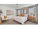 Well-lit main bedroom with stylish decor, a comfortable bed, and large windows at 24052 W Pima St, Buckeye, AZ 85326