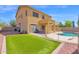 Large backyard with artificial grass, patio, and a fenced kidney-shaped pool, perfect for outdoor enjoyment at 2519 W Burgess Ln, Phoenix, AZ 85041