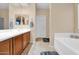 Bright bathroom with double sinks, a bath tub and tiled floor at 2519 W Burgess Ln, Phoenix, AZ 85041