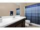 Cozy bathroom featuring a vanity, toilet, and a shower with blue accents at 2519 W Burgess Ln, Phoenix, AZ 85041