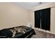 Neutral bedroom with minimal décor, black out curtains, and carpeted floors at 2519 W Burgess Ln, Phoenix, AZ 85041