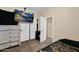 Well-lit bedroom showcasing modern TV, and three closets for storage at 2519 W Burgess Ln, Phoenix, AZ 85041